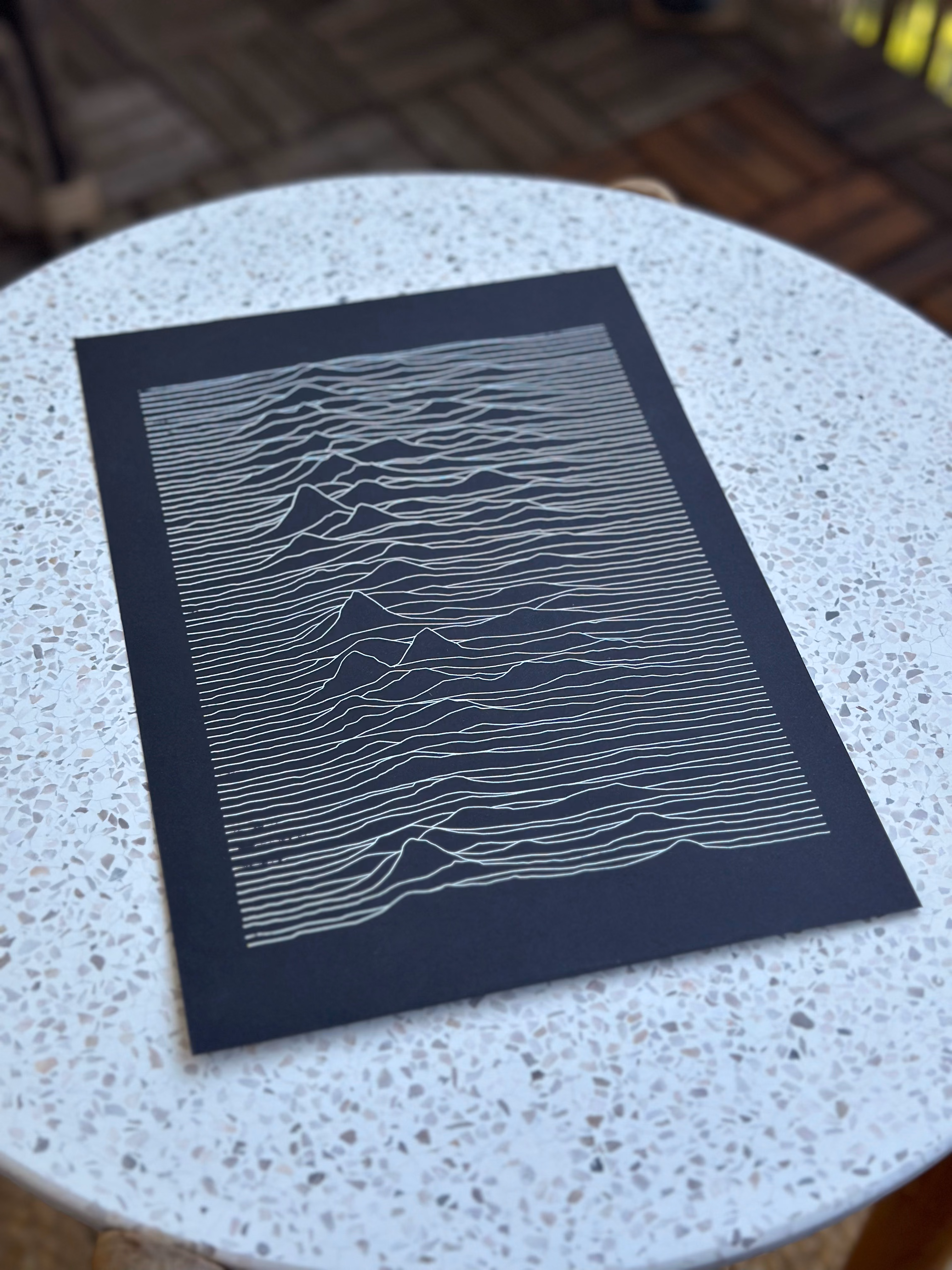 Unknown Pleasures pen plot in white ink on black paper, side angle view